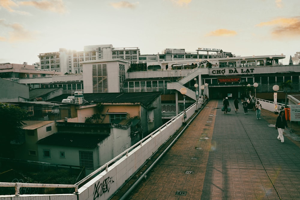 a train station with people walking on the platform