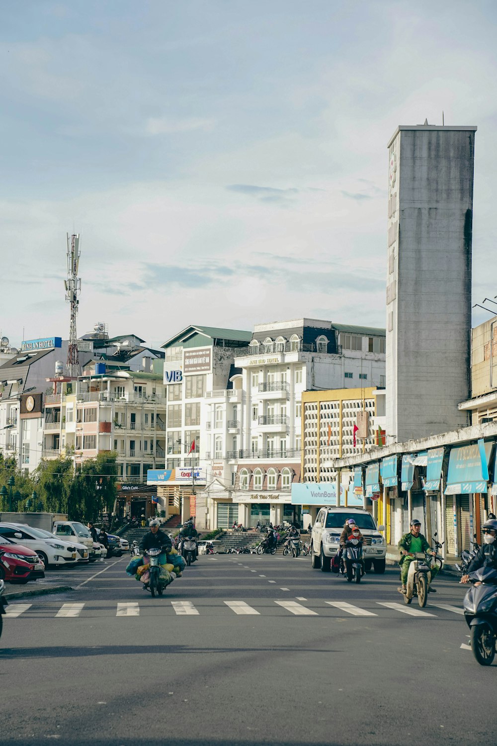 a group of people riding motorcycles down a street