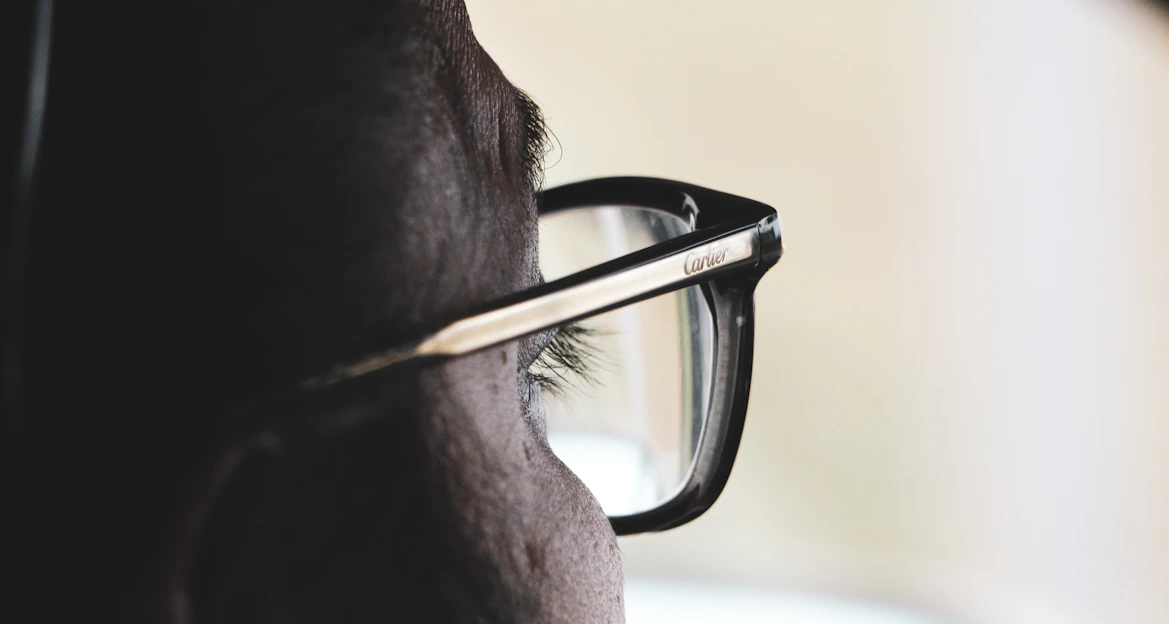 Close-up of a person wearing sleek, modern eyeglasses with a soft background.