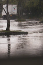 A delivery truck with rain drop logo making a stop at a local store.