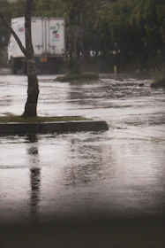 A delivery truck with rain drop logo making a stop at a local store.
