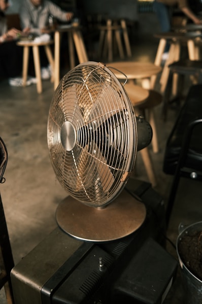 a metal fan sitting on top of a table