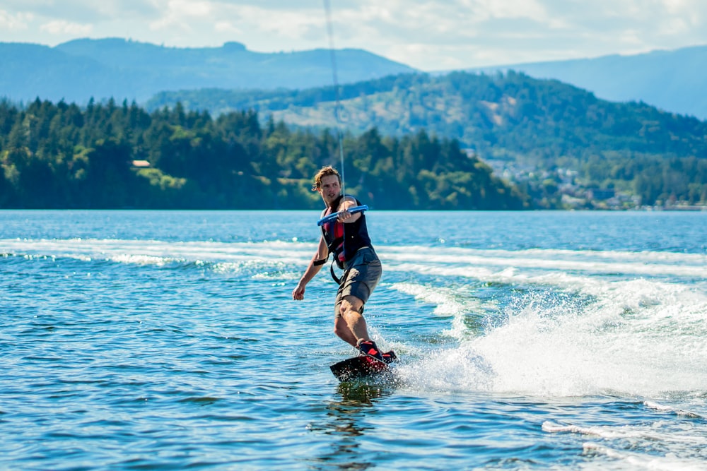 a man riding water skis on top of a lake