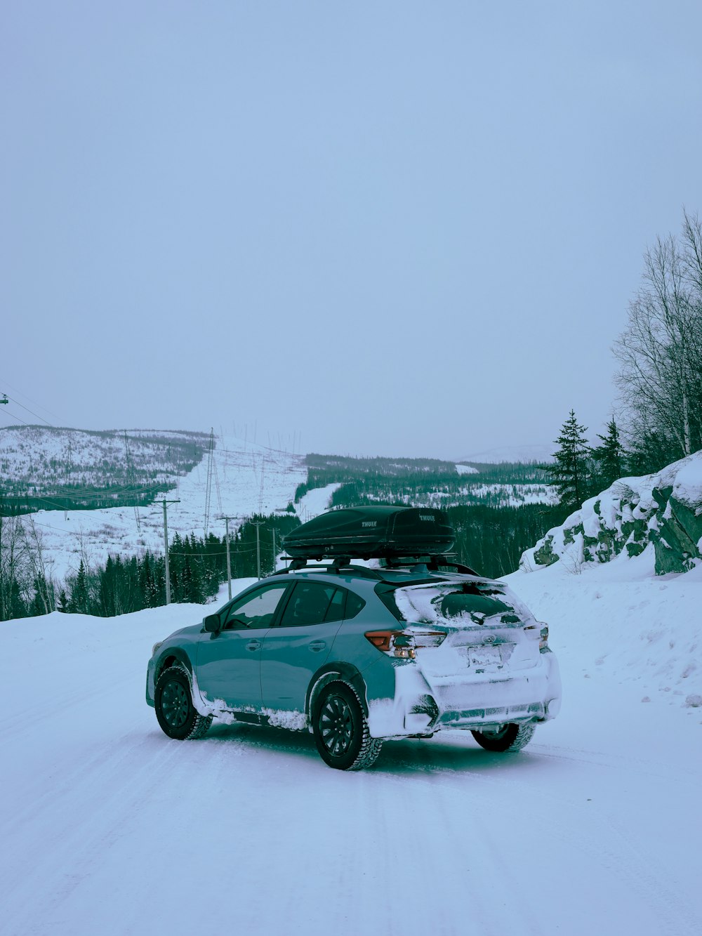 a car driving down a snow covered road