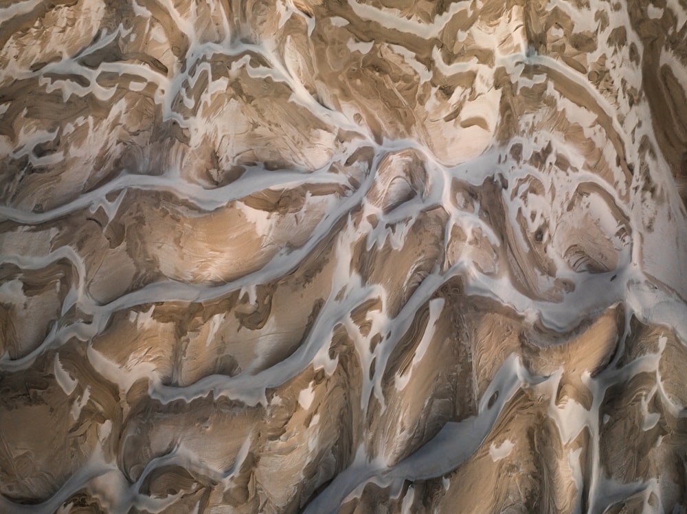 a close up of a rock face with snow on it