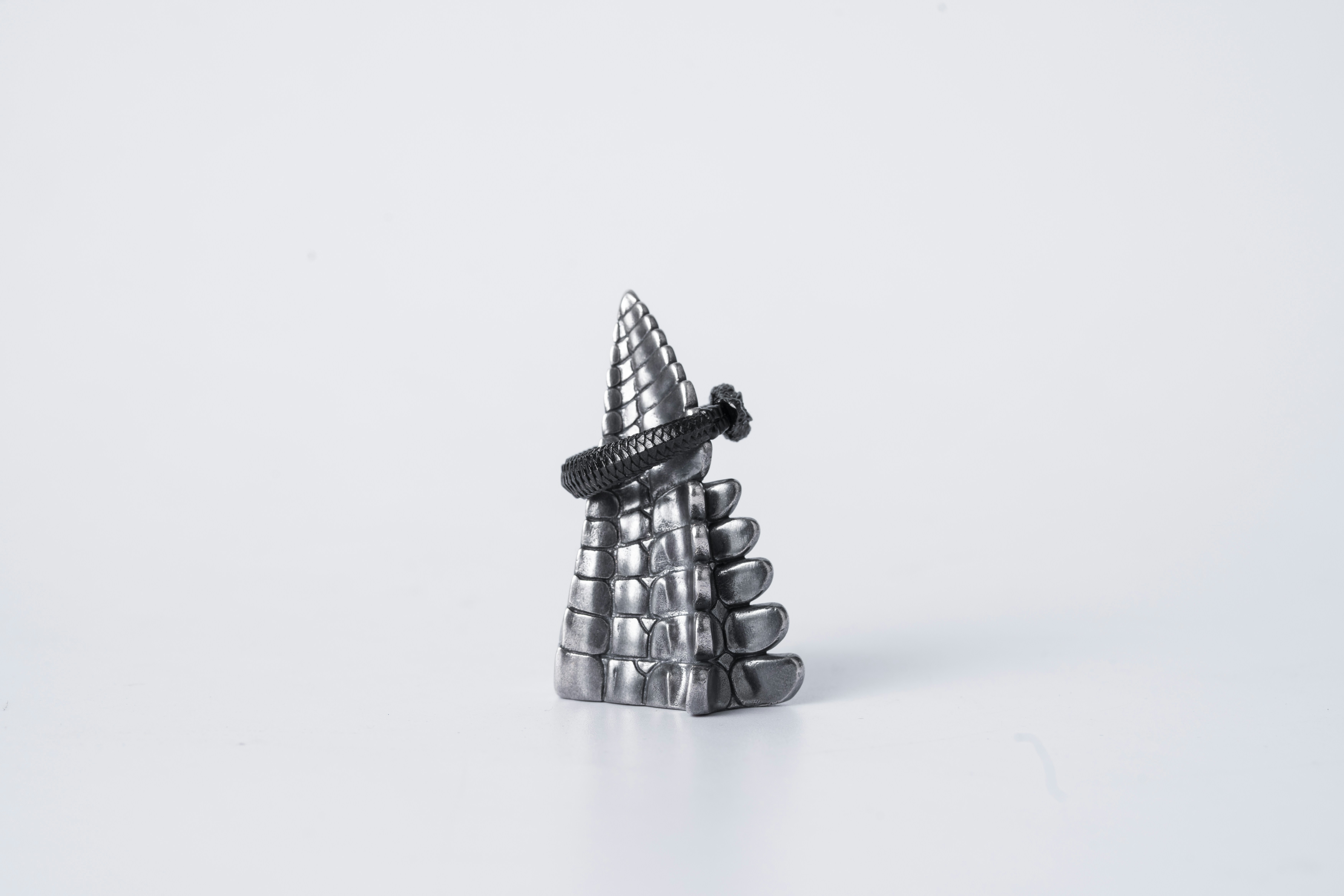 a small metal object sitting on top of a white surface