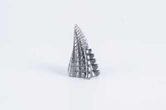 A colorful abstract sculpture set against a minimalist background.