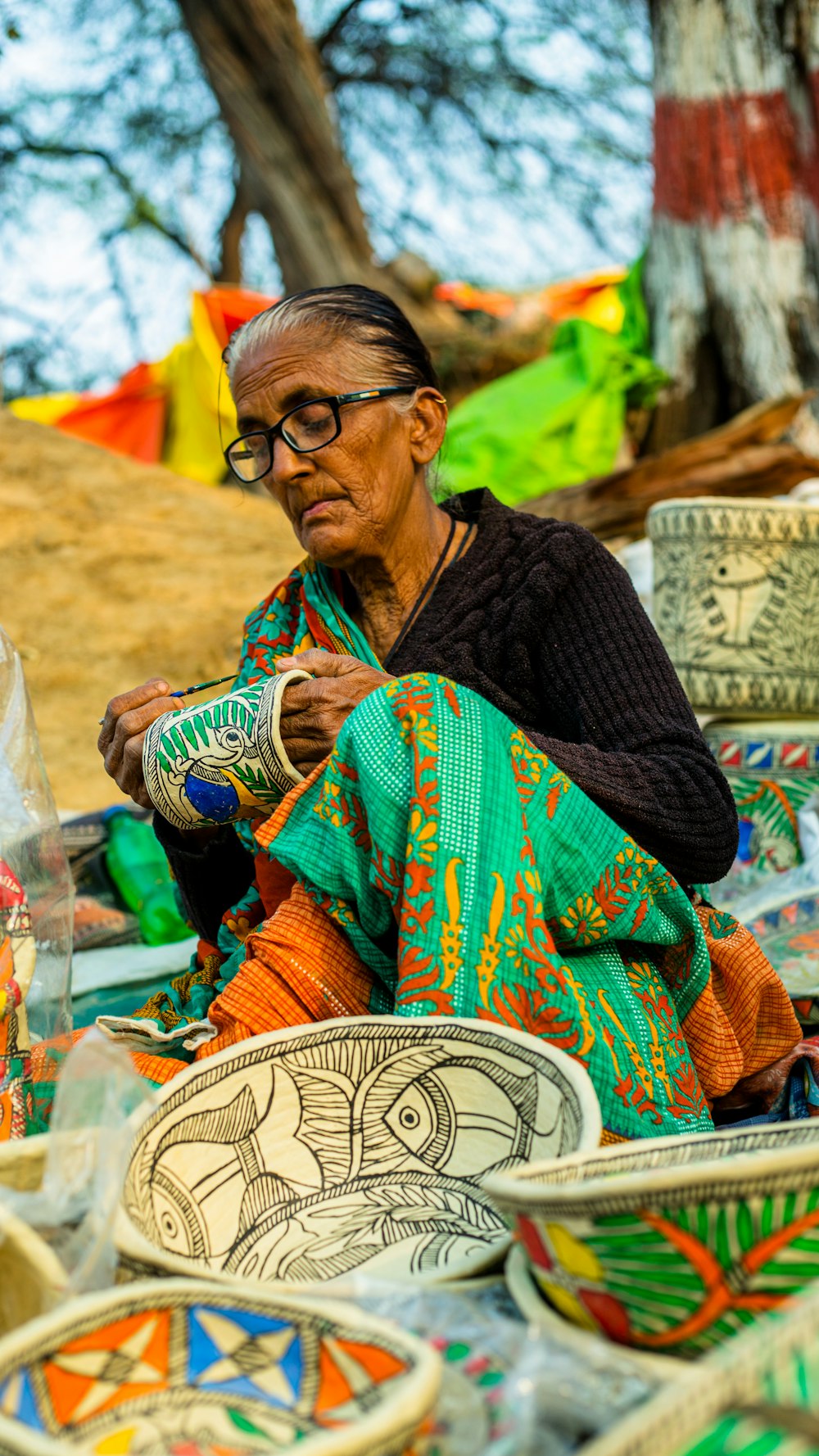 a woman sitting in front of a pile of bowls