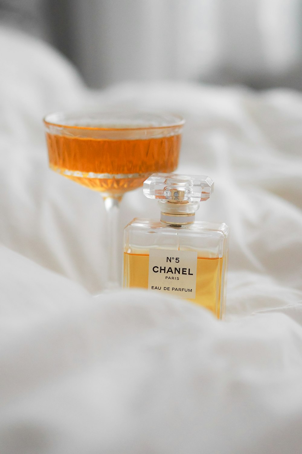 A bottle of chanel no 5 next to a glass photo – Free Paris Image
