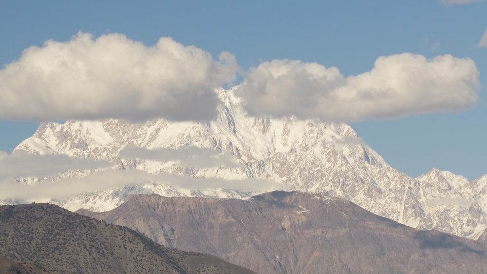 a mountain range with clouds in the sky