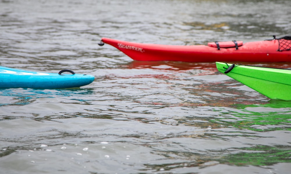 a couple of kayaks floating on top of a body of water