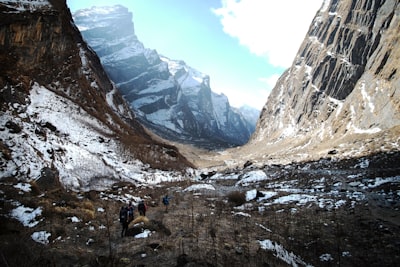 a group of people walking up a snow covered mountain