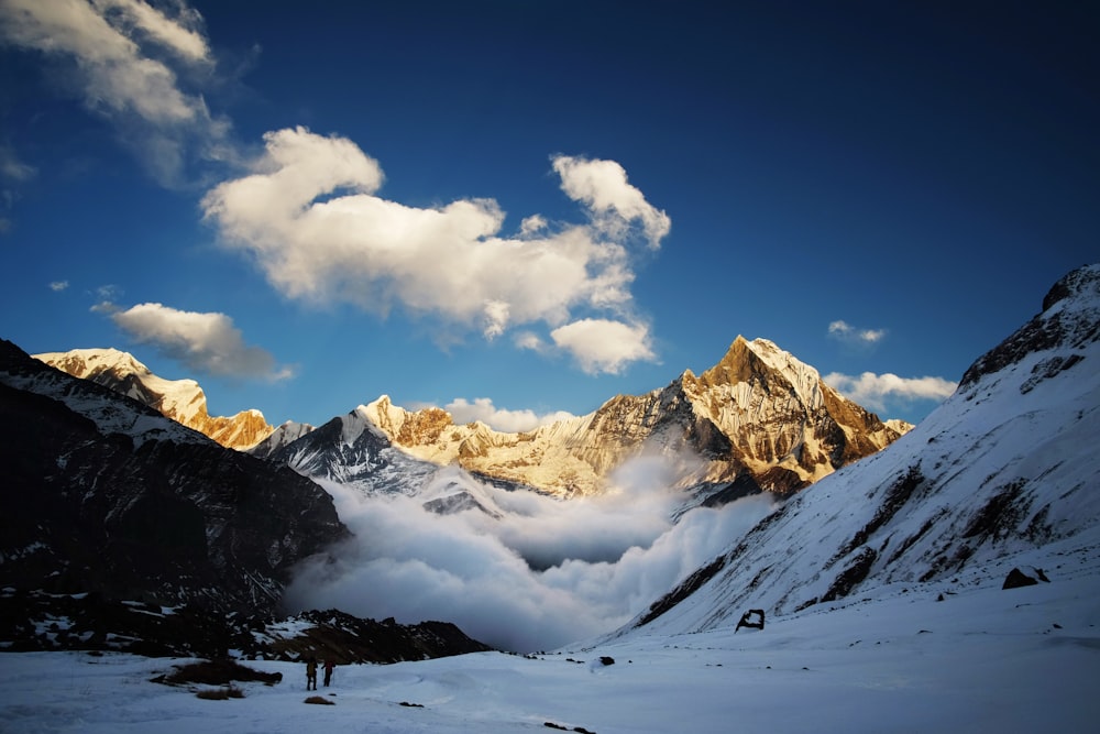 a man standing on top of a snow covered mountain