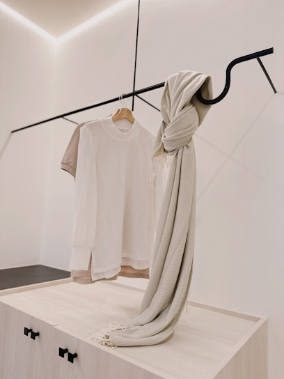 A sleek display of modern casual wear on a minimalist rack.