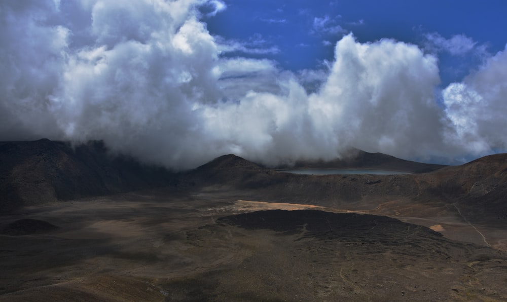 a view of a mountain range with clouds in the sky