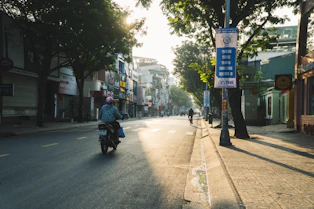 a person riding a motorcycle down a street
