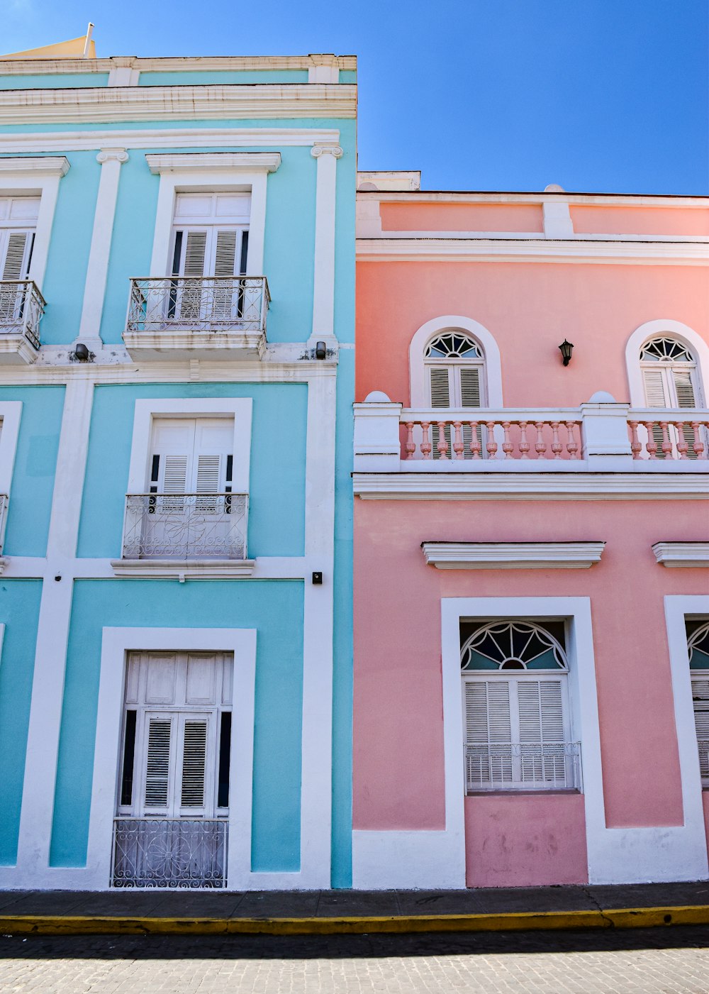 a row of multicolored buildings with balconies and balconies