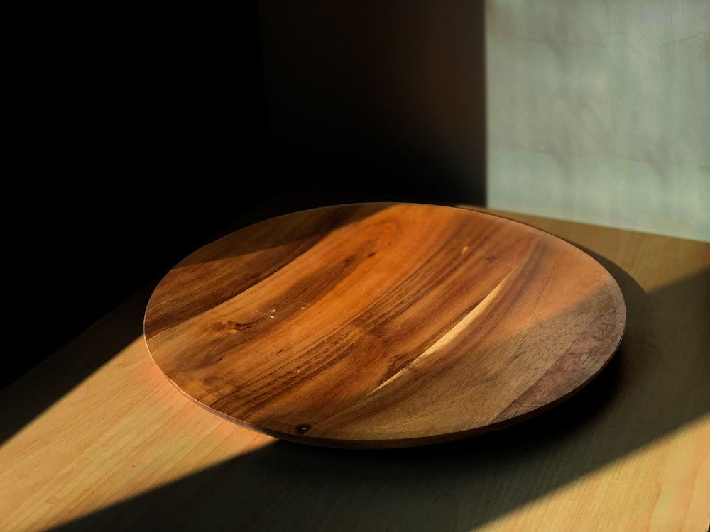 a wooden plate sitting on top of a wooden table