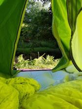 A panoramic view of a luxury Swiss tent set up amidst lush greenery at an eco-resort.