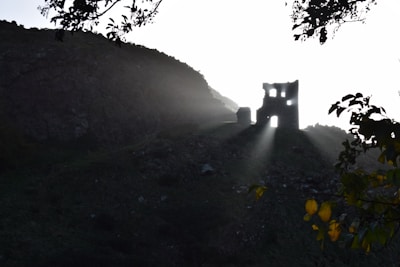 Natural light illuminating a section of uncovered ruins with earth tones and subtle shadows emphasizing depth.