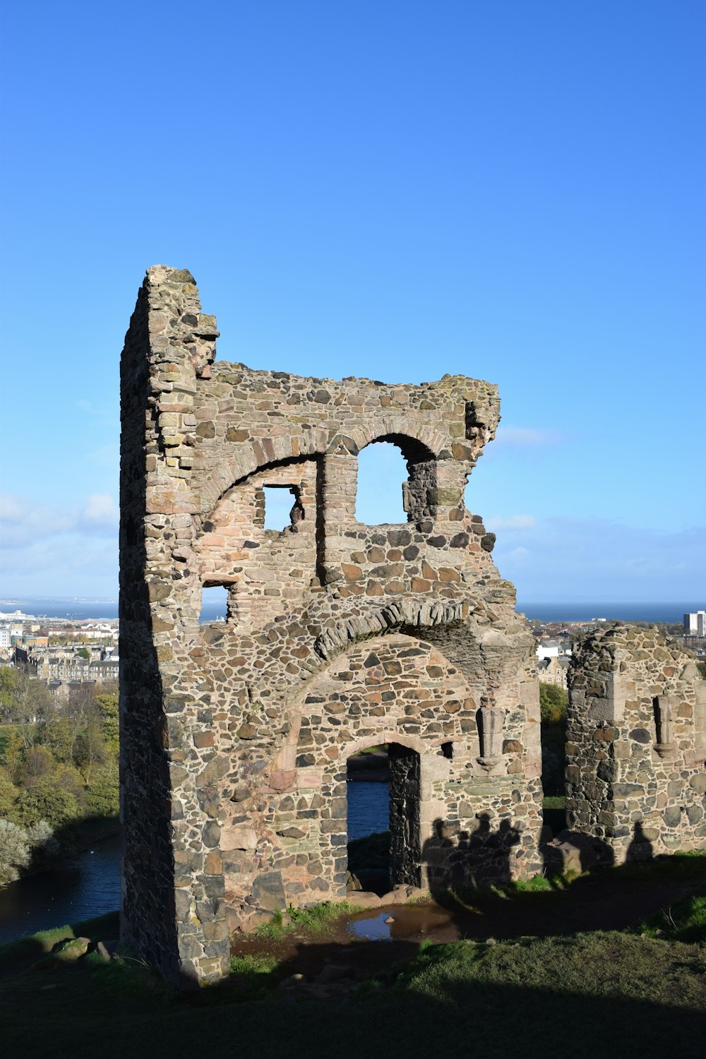 the ruins of an old castle overlooking a body of water