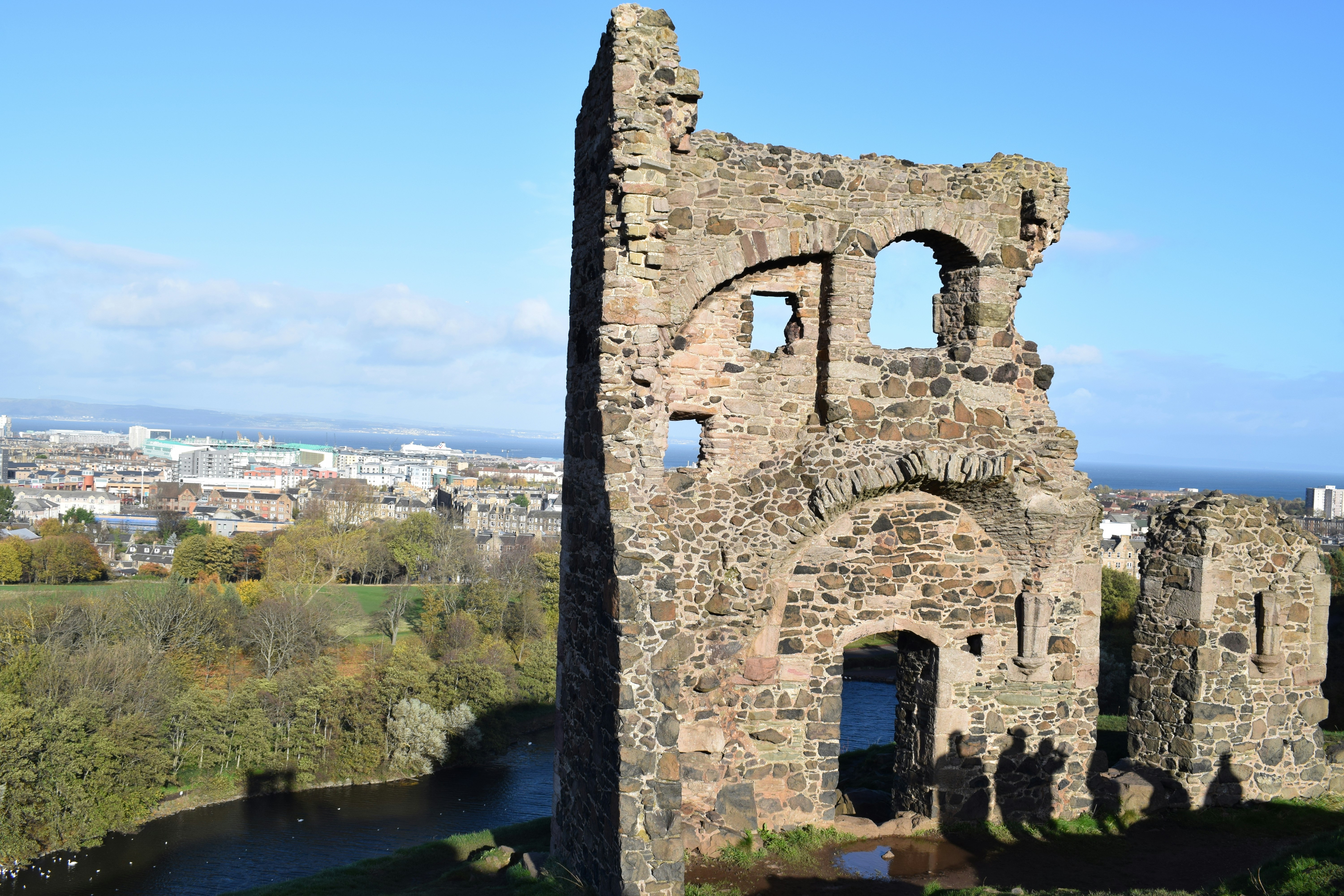 the ruins of a castle overlooking a river, 