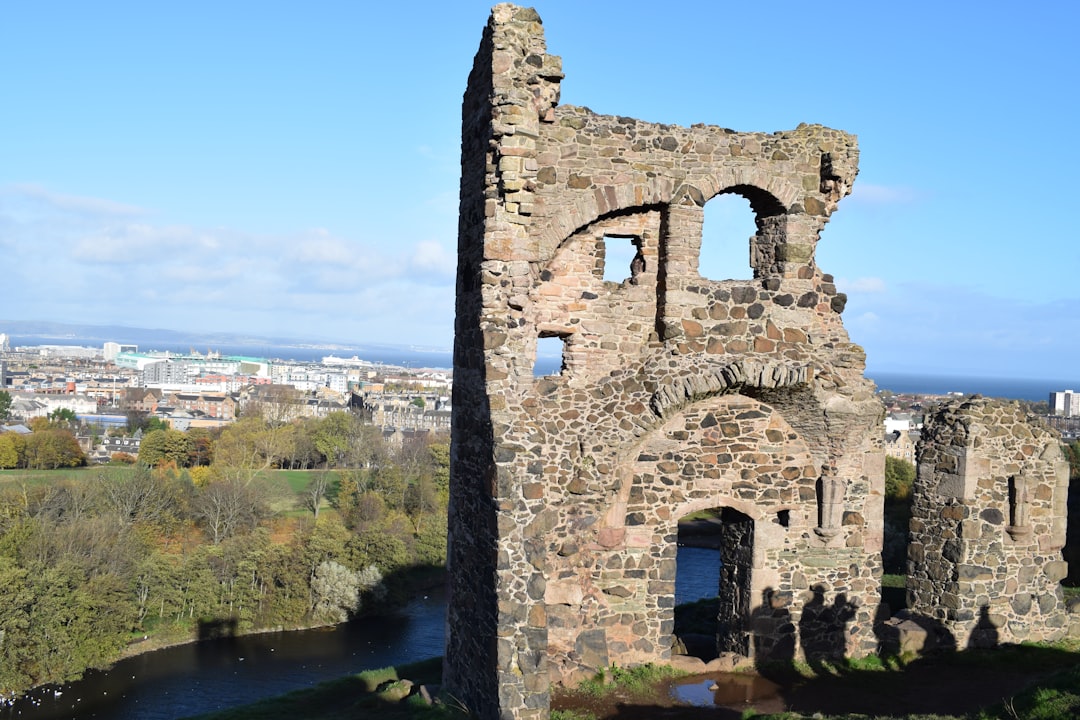 the ruins of a castle overlooking a river,