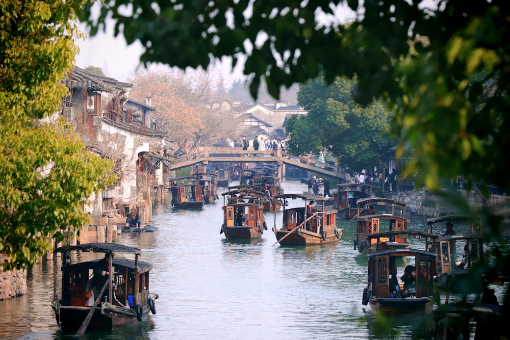 a river filled with lots of boats floating on top of it