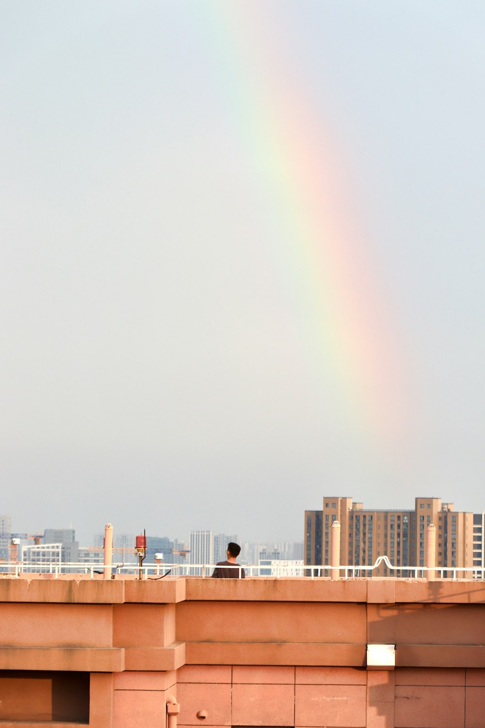 a rainbow in the sky over a city