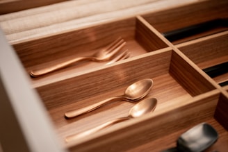 a drawer with utensils and spoons in it