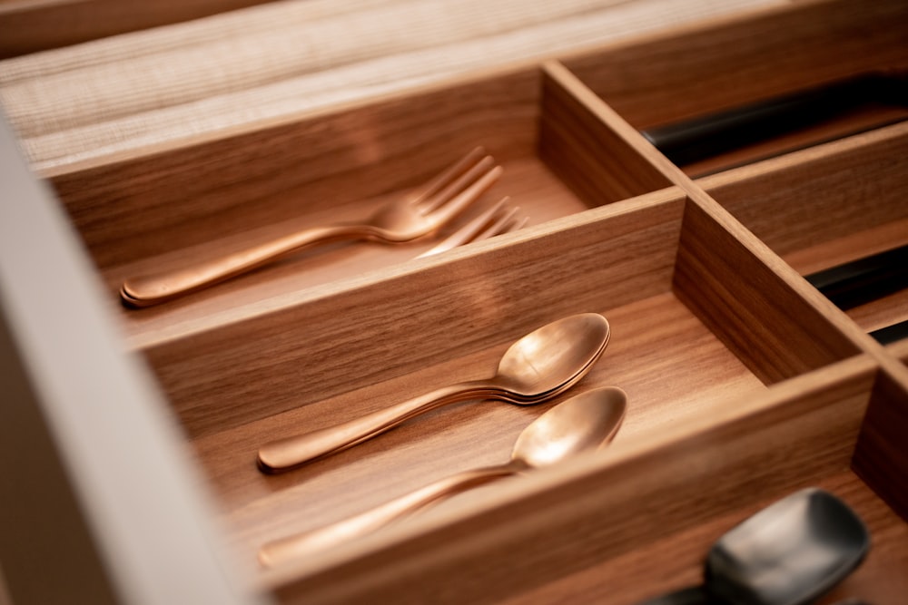 a drawer with utensils and spoons in it