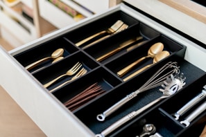 a drawer filled with silverware and wooden spoons