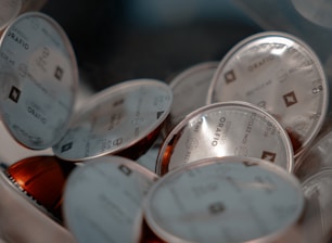 Eco-friendly coffee capsules spilling out of a biodegradable package on a natural background.