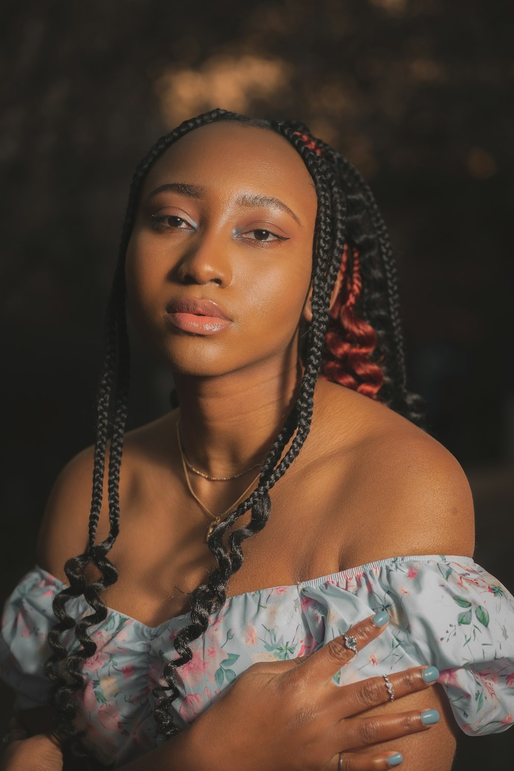 a woman with braids wearing a blue dress