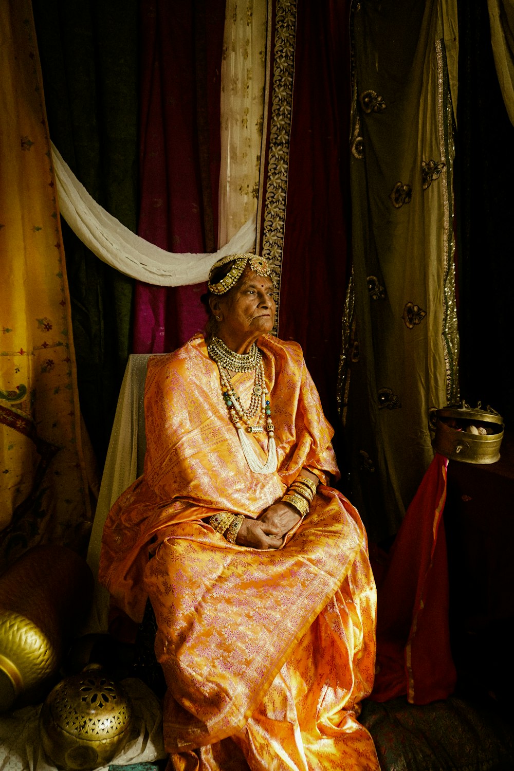 a woman in a yellow dress sitting in a room