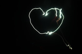 A heart-shaped pattern glowing within a cluster of cells, illustrating universal law in our DNA.