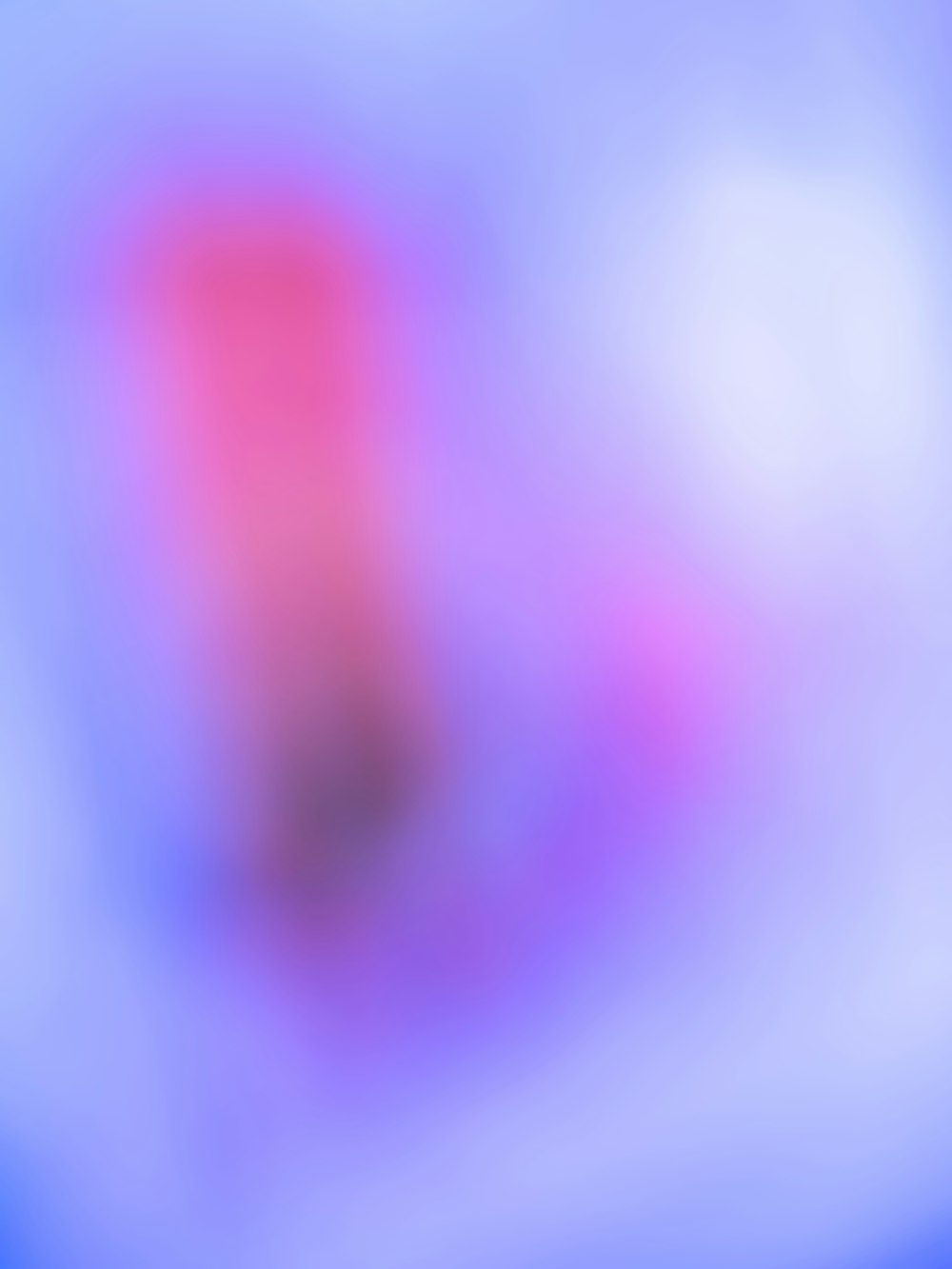 a blurry image of a pink and blue background