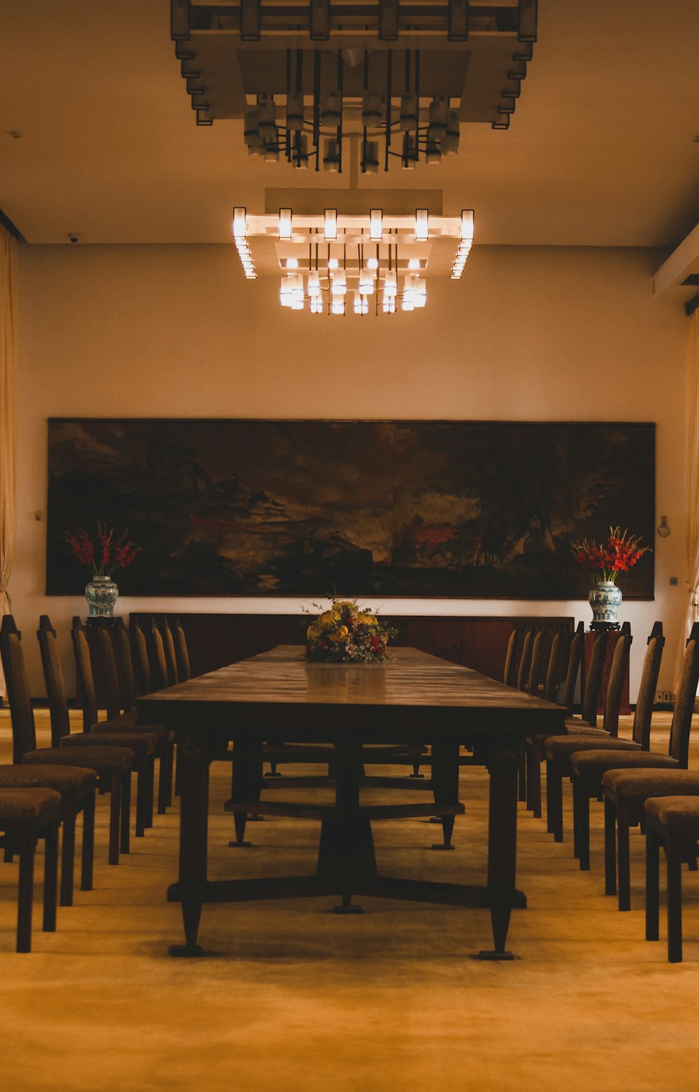 a large wooden table surrounded by brown chairs