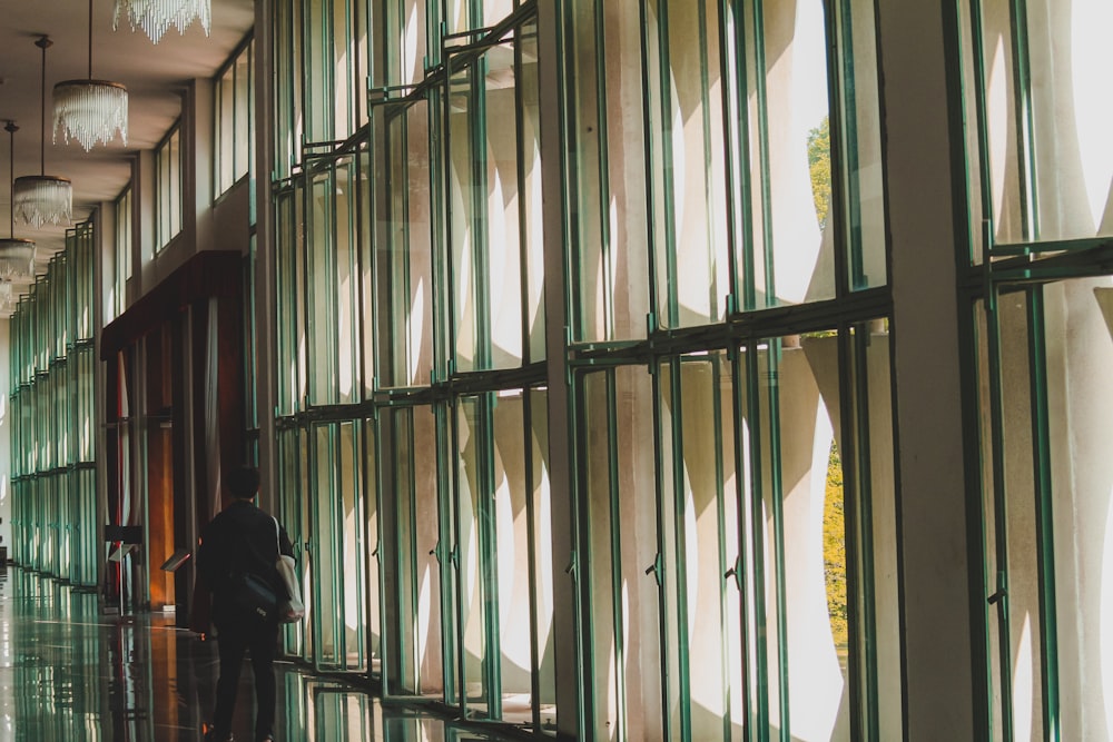 a man standing in front of a glass wall