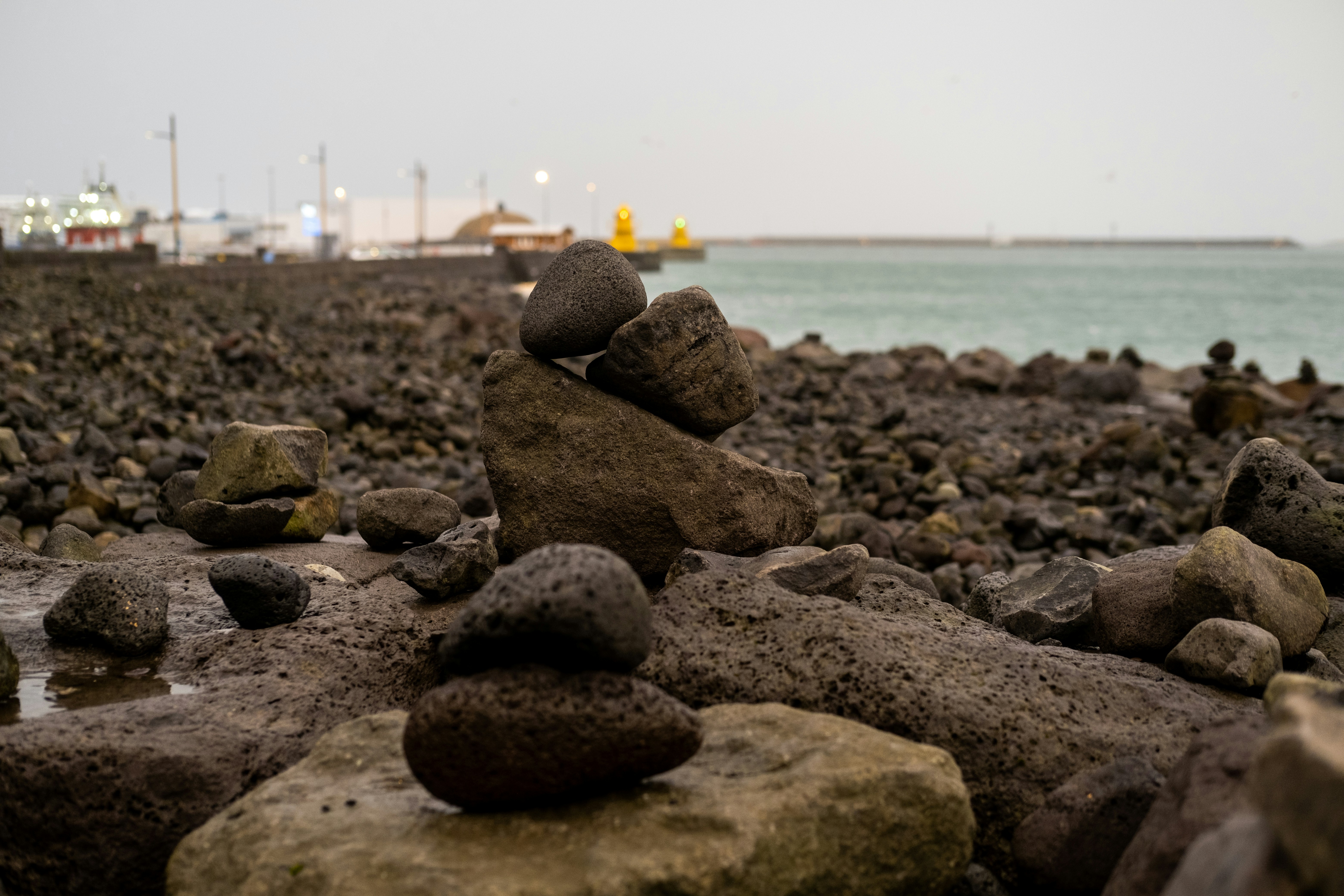 a pile of rocks sitting on top of a rocky beach