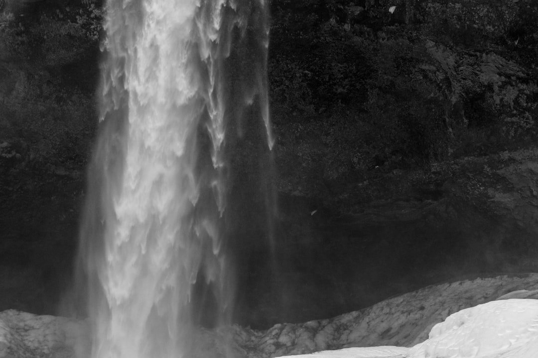 a black and white photo of a waterfall,