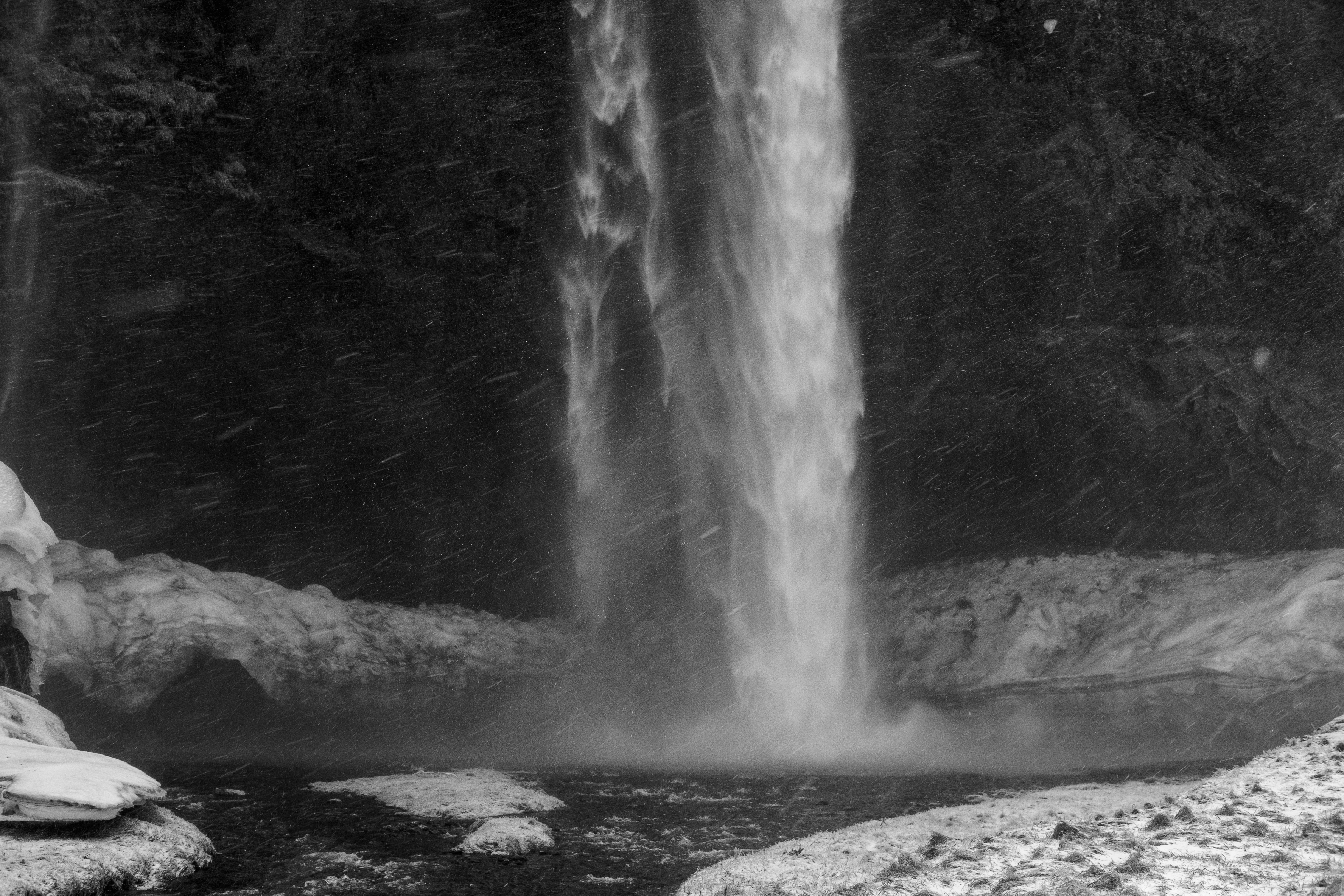 a black and white photo of a waterfall