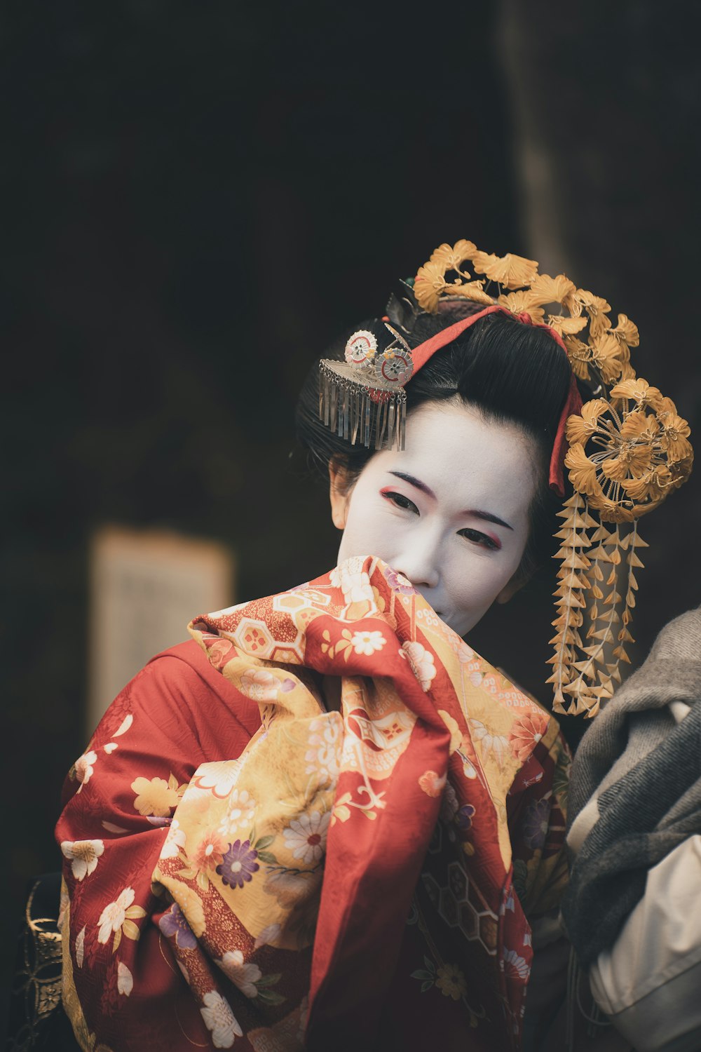 a woman in a geisha costume with a dragon on her head