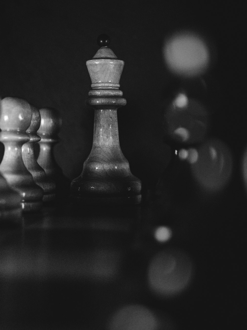 a black and white photo of a chess set