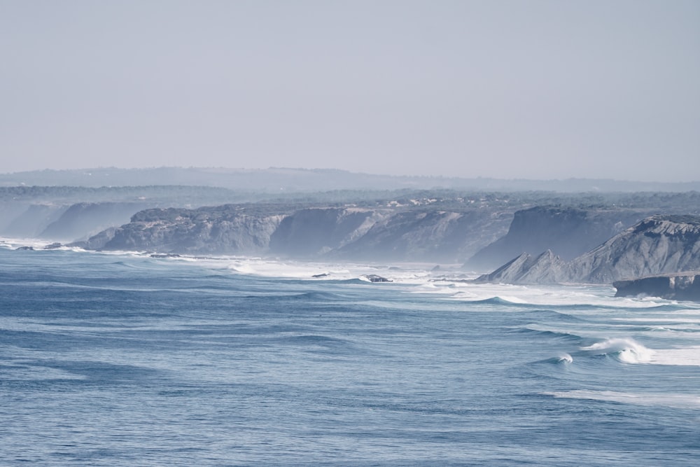 a body of water with waves coming in to shore