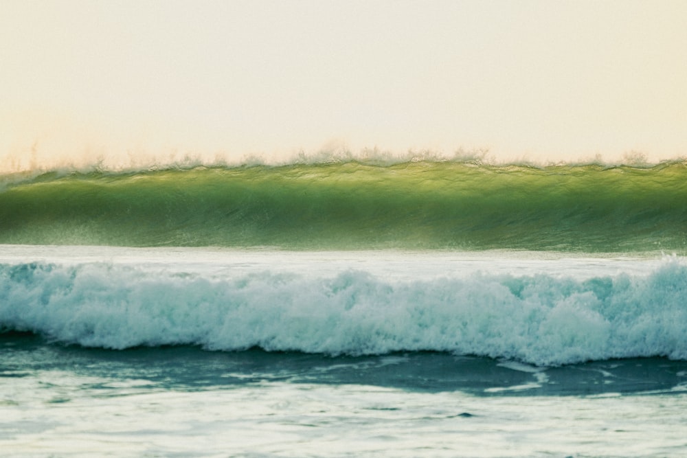 a man riding a wave on top of a surfboard