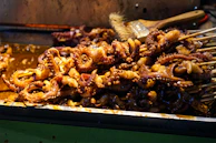 The open kitchen with chefs grilling fresh octopus, visible to all diners.