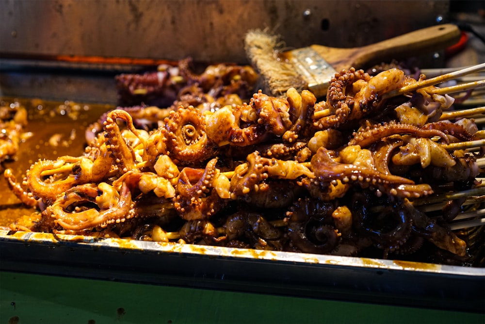 a pile of fried food sitting on top of a pan