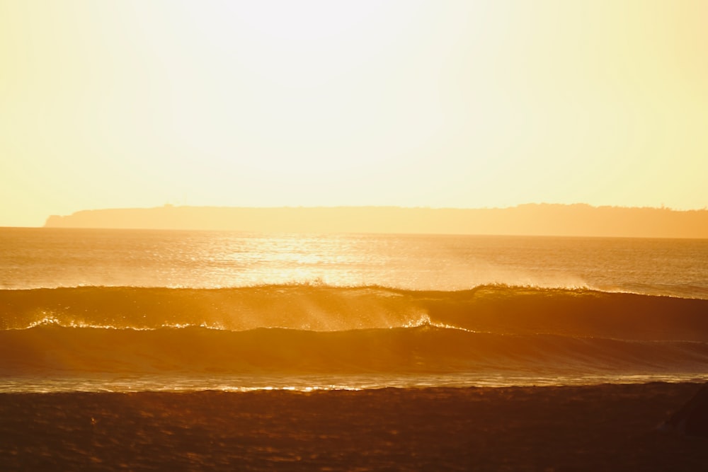 a person riding a surfboard on a wave in the ocean