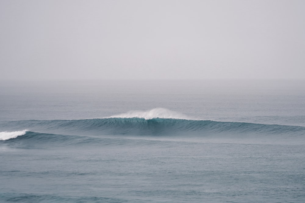 a person riding a wave on top of a surfboard